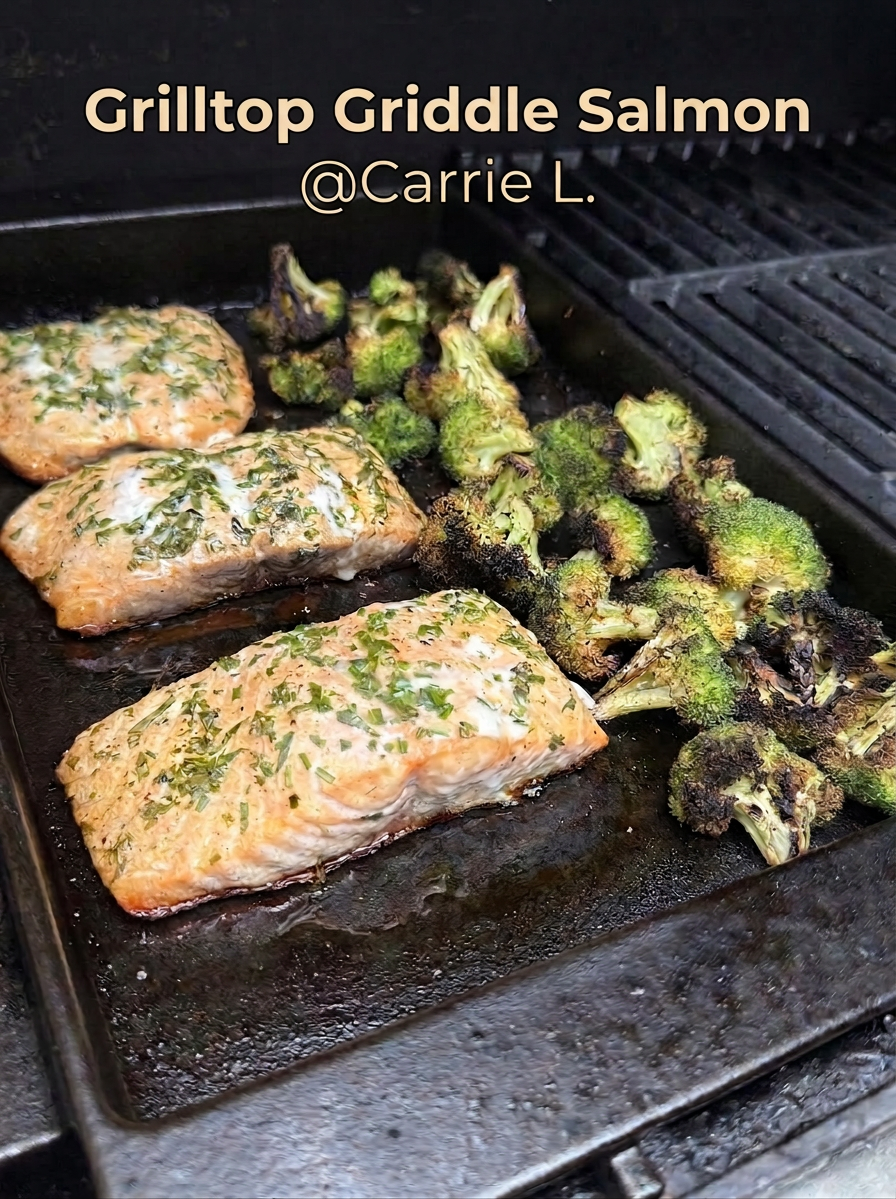 Grilled salmon with charred broccoli on griddle Salmon fillets and broccoli florets cooking on a black metal griddle
